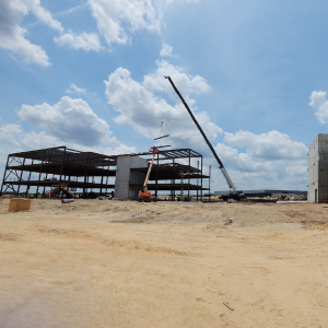 Steel structure construction site with cranes and layout markings
